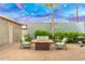 Inviting backyard with fire pit, seating, well-maintained landscaping, and privacy fence for relaxed outdoor enjoyment at 717 E Palmaire Ave, Phoenix, AZ 85020