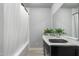 Contemporary bathroom featuring a vanity with sleek black countertop, chrome fixtures, and a shower-tub combo at 717 E Palmaire Ave, Phoenix, AZ 85020