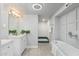 Bathroom with double vanity, bathtub, and stand up shower at 717 E Palmaire Ave, Phoenix, AZ 85020