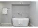 Bathroom featuring a modern bathtub with a tiled wall accent at 717 E Palmaire Ave, Phoenix, AZ 85020