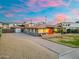 Charming single-story home featuring a red front door, a well-manicured lawn, and a spacious driveway at 717 E Palmaire Ave, Phoenix, AZ 85020
