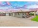 An inviting home exterior featuring a spacious driveway and charming outdoor seating area at 717 E Palmaire Ave, Phoenix, AZ 85020