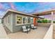 Charming home featuring an inviting front porch with stylish seating and a vibrant orange door at 717 E Palmaire Ave, Phoenix, AZ 85020