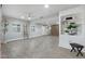 Bright living room with neutral paint, modern floors, a ceiling fan, and custom built-in shelving at 717 E Palmaire Ave, Phoenix, AZ 85020