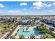 A beautiful aerial view of the community pool surrounded by homes, landscaping and clear blue skies at 734 W Winchester Dr, Chandler, AZ 85286
