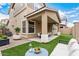 Backyard oasis with covered patio, artificial turf, and stylish outdoor furniture at 734 W Winchester Dr, Chandler, AZ 85286