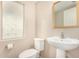 Cozy half-bathroom with a pedestal sink, toilet, and a patterned window at 734 W Winchester Dr, Chandler, AZ 85286