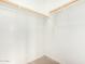 Bright closet featuring carpet and two wooden rods for ample storage at 734 W Winchester Dr, Chandler, AZ 85286