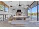 A clubhouse interior view with a cozy fireplace, large table, chairs, and an outdoor view at 734 W Winchester Dr, Chandler, AZ 85286