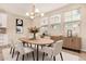 Bright dining room featuring a modern chandelier, ample natural light, and neutral decor at 734 W Winchester Dr, Chandler, AZ 85286