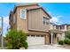 Charming home featuring a two-car garage, neutral stucco, vertical siding and lush greenery for a welcoming curb appeal at 734 W Winchester Dr, Chandler, AZ 85286