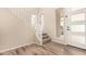 Bright foyer featuring wood-look flooring, a staircase with white railing, and a modern front door at 734 W Winchester Dr, Chandler, AZ 85286