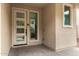 Contemporary front entrance featuring a modern door with glass inserts, sidelight window, and textured stucco at 734 W Winchester Dr, Chandler, AZ 85286