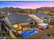 Aerial view of backyard oasis with pool, spa, pergola and outdoor kitchen at 8149 E Jaeger St, Mesa, AZ 85207