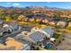 Expansive aerial view showcases the neighborhood's homes, mountains in the background, and private pool and pergola at 8149 E Jaeger St, Mesa, AZ 85207