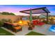 Backyard featuring a built-in fire pit, lounge seating, and view of the swimming pool and hot tub at 8149 E Jaeger St, Mesa, AZ 85207