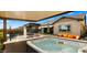 Luxurious backyard with a hot tub, outdoor kitchen, a stunning pool, and comfortable lounge seating, perfect for entertaining at 8149 E Jaeger St, Mesa, AZ 85207