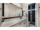 Modern bathroom with white cabinets, an expansive mirror, and a tiled shower at 8149 E Jaeger St, Mesa, AZ 85207
