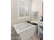 Bright bathroom featuring a soaking tub, plantation shutters, and neutral tones at 8149 E Jaeger St, Mesa, AZ 85207