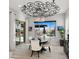 Elegant dining area featuring a round table, stylish chandelier, and outdoor view of the pool and patio at 8149 E Jaeger St, Mesa, AZ 85207