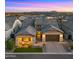 Beautiful home boasts a three-car garage, manicured lawn, and charming covered porch at 8149 E Jaeger St, Mesa, AZ 85207