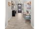 Inviting foyer with decorative art, a stylish bench, and a view of the front door with sidelights at 8149 E Jaeger St, Mesa, AZ 85207