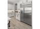 Modern kitchen featuring white cabinets, stainless steel KitchenAid fridge and light wood-look tile flooring at 8149 E Jaeger St, Mesa, AZ 85207