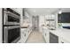 Sleek kitchen featuring stainless steel appliances, white cabinetry, and a spacious layout at 8149 E Jaeger St, Mesa, AZ 85207