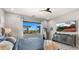 Tranquil bedroom featuring a king bed, backyard views, a ceiling fan, and a mounted flat screen tv at 8149 E Jaeger St, Mesa, AZ 85207