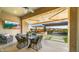 Charming covered outdoor dining area with a view of the pool, creating the perfect setting for alfresco meals at 8149 E Jaeger St, Mesa, AZ 85207