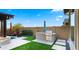 Well-equipped outdoor kitchen and grill area, with a view of the pool and lounge seating, ideal for summer entertaining at 8149 E Jaeger St, Mesa, AZ 85207