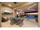 Covered patio with dining area and TV, fire pit, and a view of the pool at 8149 E Jaeger St, Mesa, AZ 85207