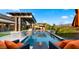 Relaxing poolside seating overlooking the pool with water features, offering a tranquil backyard escape at 8149 E Jaeger St, Mesa, AZ 85207
