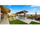 Expansive backyard with a sparkling pool, outdoor seating, and lush greenery, creating an inviting space for leisure at 8149 E Jaeger St, Mesa, AZ 85207