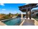 Stunning backyard pool with a cascading water feature, surrounded by lush landscaping and elegant stone accents at 8149 E Jaeger St, Mesa, AZ 85207