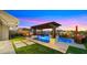 Inviting backyard pool with pergola, travertine deck, and outdoor living space at 8149 E Jaeger St, Mesa, AZ 85207