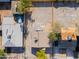 Aerial view showcasing the property's layout and adjacent expansive, open lot at 832 S Drew St, Mesa, AZ 85210