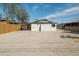 Back exterior of house with a large yard, a covered patio, and a white exterior at 832 S Drew St, Mesa, AZ 85210