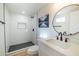 Modern bathroom featuring white subway tile shower, black fixtures, and stylish round mirror at 832 S Drew St, Mesa, AZ 85210