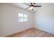 Bright bedroom features wood-look floors, window and ceiling fan provides fresh air and comfort at 832 S Drew St, Mesa, AZ 85210