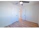 Bedroom with modern ceiling fan and wood-look flooring, bathroom visible in attached ensuite at 832 S Drew St, Mesa, AZ 85210