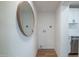 Hallway area leading to the kitchen featuring laundry hook-ups and decoratice mirror at 832 S Drew St, Mesa, AZ 85210