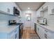 Modern kitchen featuring white cabinets, quartz countertops, and stainless steel appliances at 832 S Drew St, Mesa, AZ 85210