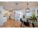 Open-concept interior boasting a glass dining table, modern light fixture, and sleek flooring at 832 S Drew St, Mesa, AZ 85210