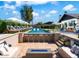 Beautiful backyard with a sparkling pool, stylish bar seating, comfortable lounge, and a modern fire pit at 8734 E Amelia Ave, Scottsdale, AZ 85251