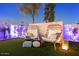 Backyard seating area with stylish egg chairs, plush cushions, and ambient lighting at 8734 E Amelia Ave, Scottsdale, AZ 85251
