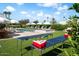 Outdoor backyard features pool with lounge seating, beer pong tables, and manicured landscaping for entertaining at 8734 E Amelia Ave, Scottsdale, AZ 85251