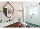 Modern bathroom featuring a glass enclosed shower, and a stylish vanity at 8734 E Amelia Ave, Scottsdale, AZ 85251