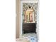 Stylish ensuite bathroom featuring decorative tile floor and accent wall at 8734 E Amelia Ave, Scottsdale, AZ 85251