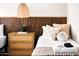 Bright bedroom featuring a wood slat headboard, woven nightstand, and a decorative hanging light fixture at 8734 E Amelia Ave, Scottsdale, AZ 85251